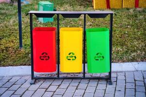 Iron multi-colored containers for separate waste collection. photo