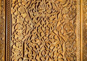 Fragment of an ancient carved wooden door. Ornate. photo