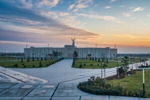 UZBEKISTAN, TASHKENT - JANUARY 4, 2023 The territory of the park New Uzbekistan with Monument of Independence in the form of a stele with a Humo bird at sunset. photo