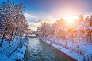 Sunset or dawn on a canal with non-freezing water on a cold winter day. photo