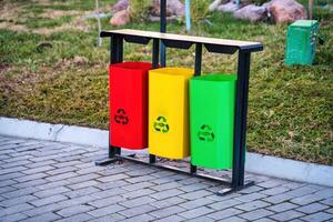 Iron multi-colored containers for separate waste collection. photo