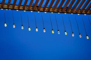 Holiday garlands with lamps against the black night sky. photo