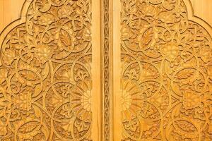 Carved wooden doors with patterns and mosaics. photo