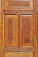 Carved wooden doors with patterns and mosaics. photo