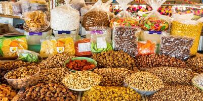 Oriental dried fruits and nuts on the counter of the bazaar. photo