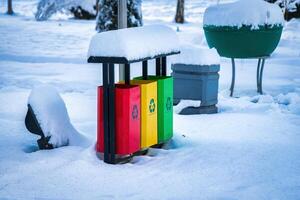 Iron multi-colored containers for separate waste collection. photo