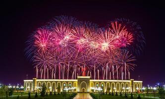Uzbekistan, Tashkent - September 1, 2023 Multi-colored fireworks over the Independence Monument in Yangi Uzbekistan Park in Tashkent on Independence Day. photo