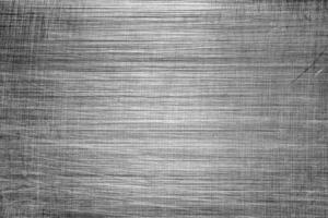 Monochrome texture of shiny scratched metal. Abstract background. photo