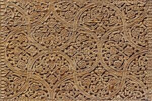 Fragment of an ancient carved wooden door. Ornate. photo