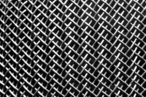 Monochrome texture of a shiny metal colander or grate. Abstract background. photo