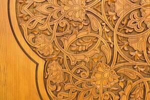 Carved wooden doors with patterns and mosaics. photo