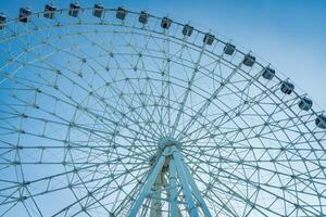 Ferris wheel at sunset or sunrise in an amusement park. photo