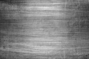 Monochrome texture of shiny scratched metal. Abstract background. photo