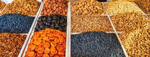 Oriental dried fruits and nuts on the counter of the bazaar. photo