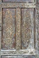 Carved wooden doors with patterns and mosaics. Abstract background for design. photo