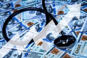 Stethoscope on the background of one hundred dollar bills. photo