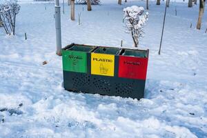 Iron multi-colored containers for separate waste collection. photo