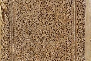 Fragment of an ancient carved wooden door. Ornate. photo