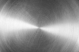 Stainless steel or aluminium circular brushed shiny metal texture. Abstract metallic background. Circle shape. photo