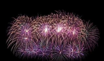 Colorful celebration fireworks isolated on a black sky background. photo