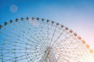 Ferris wheel at sunset or sunrise in an amusement park. photo