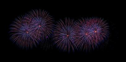 Colorful celebration fireworks isolated on a black sky background. photo