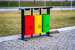 Iron multi-colored containers for separate waste collection. photo