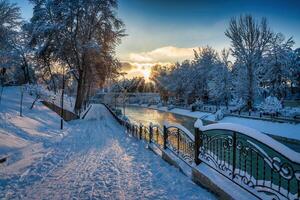 Sunset or dawn on a canal with non-freezing water on a cold winter day. photo