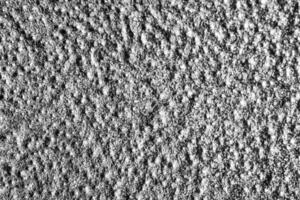 Monochrome texture of shiny grained metal. Abstract background. photo