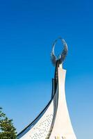 UZBEKISTAN, TASHKENT - SEPTEMBER 15, 2023 Monument of Independence in the form of a stele with a Humo bird on a daytime in the New Uzbekistan park in summer. photo