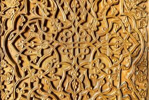 Fragment of an ancient carved wooden door. Ornate. photo