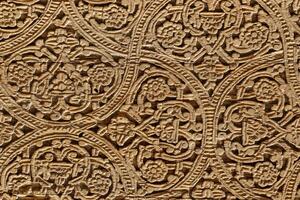 Fragment of an ancient carved wooden door. Ornate. photo