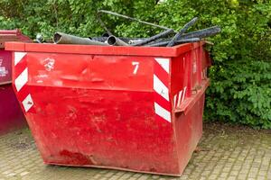 red container with construction waste photo