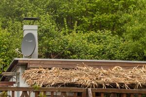 Satellite antenna on the roof of a garden shed photo