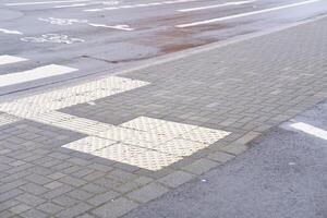 wet road with cycle path sign photo