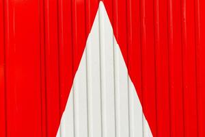 Metal wall, white arrow on red background photo