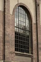 Details of an old industrial building, brick wall and windows, approx. 100 years old photo