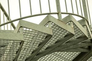 details of a metal spiral staircase in an industrial building photo