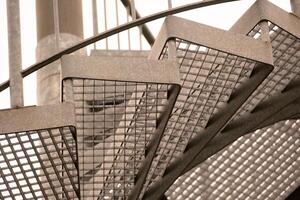 details of a metal spiral staircase in an industrial building photo
