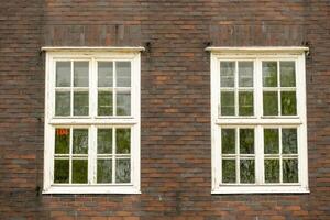 old brick building with old double windows photo