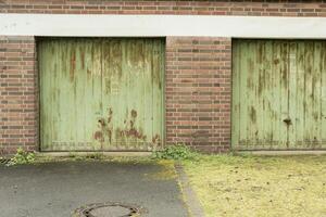 rusty green garage doors in the rain photo