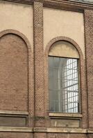 Details of an old industrial building, brick wall and windows, approx. 100 years old photo