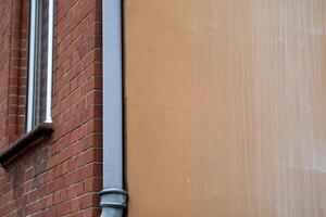 colored house corner with rain pipe photo