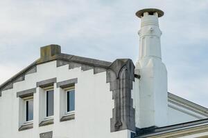 old house from the previous century with chimney photo