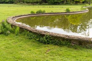 part of a large curved pond in the park photo