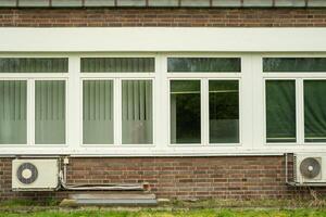 old office building with windows and air conditioning photo