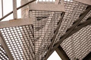 details of a metal spiral staircase in an industrial building photo