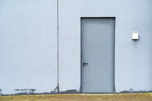 gray metal door in white house wall photo