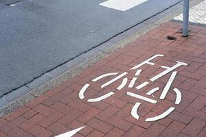 wet road with cycle path sign photo