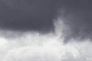 Cloudscape scenery, overcast weather above dark blue sky. Storm clouds floating in a rainy dull day with natural light. White and grey scenic environment background. Nature view. photo